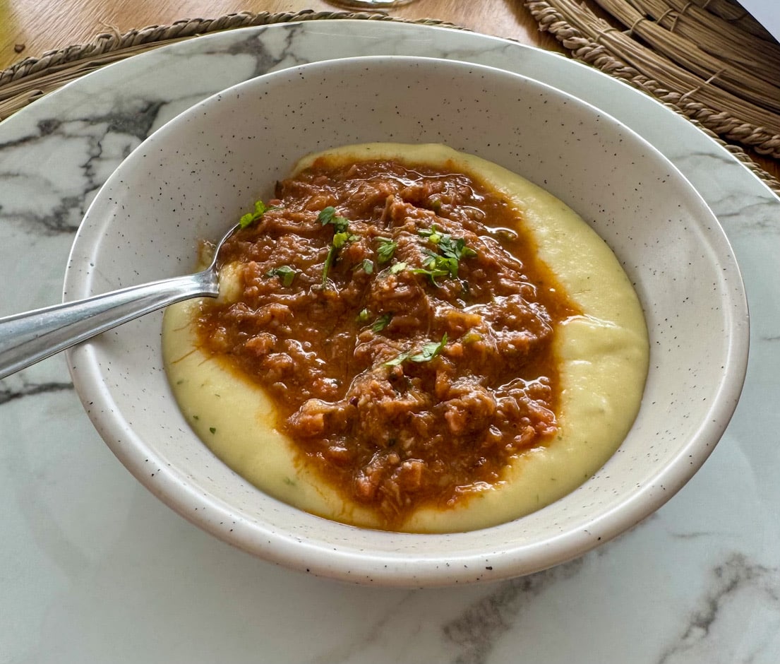 Kleiner Gruß aus der Küche im Convés Restaurant in São Francisco do Sul, Brasilien, serviert in einer Schale mit cremiger Basis und herzhaftem Ragout.